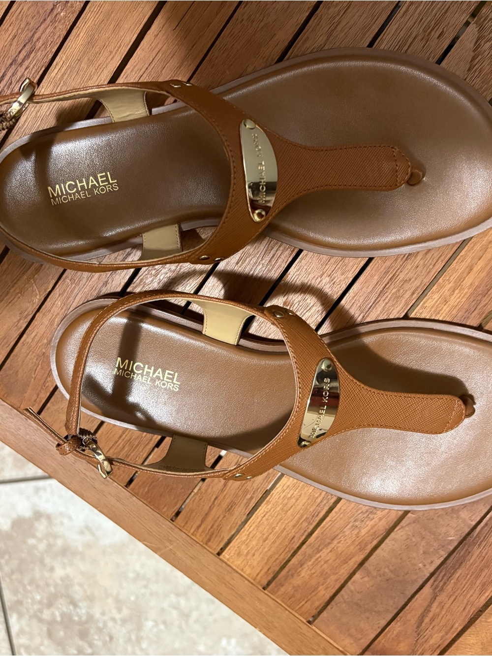MICHAEL Michael Kors Tan Leather T‑Strap Sandals with Gold Plaque
